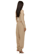 Side and back view of model wearing Formation Xion track pants in desert.