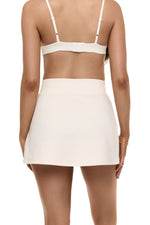 Close-up of back view of model wearing Formation Xya Skirt in ivory