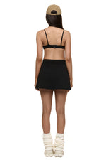 Back of model wearing Formation Xya Skirt in noir 